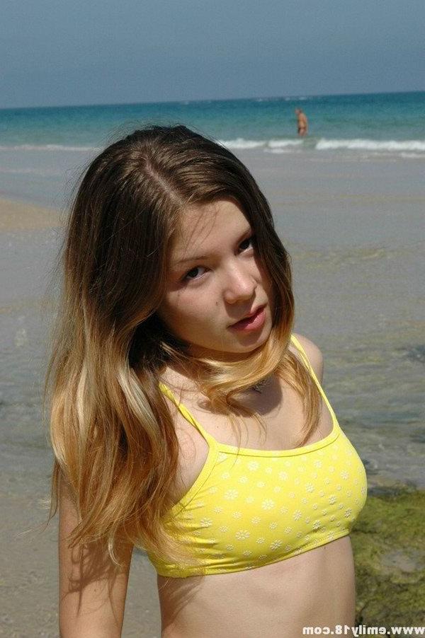15P Charming 18 year old models a yellow bikini while at the beach