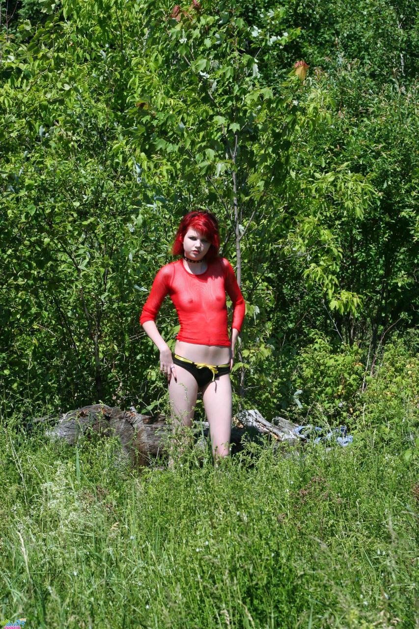 12P Pale redhead Teen Satine goes topless in an overgrown yard in a choker