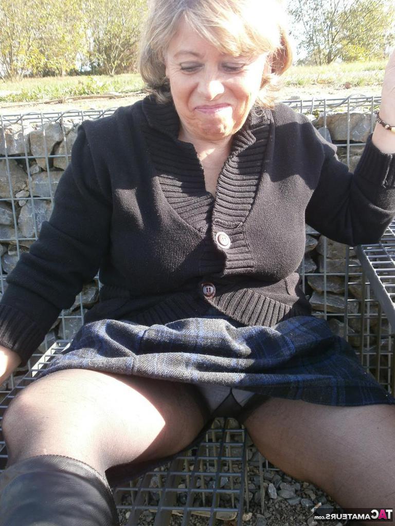 20P Older blonde amateur Caro exposes her big tits and underwear while outside