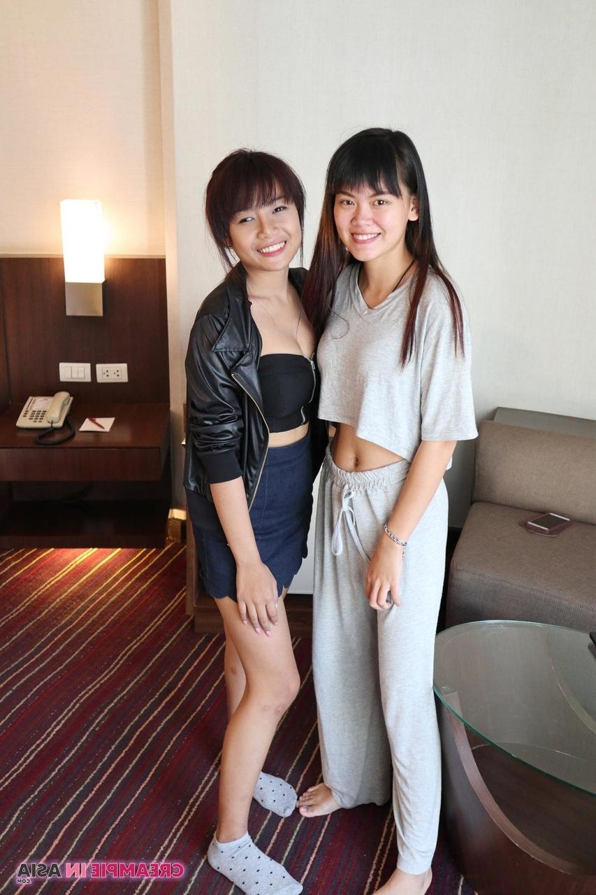 20P Petite Asian amateurs Sprite and Mon strip and pose naked together