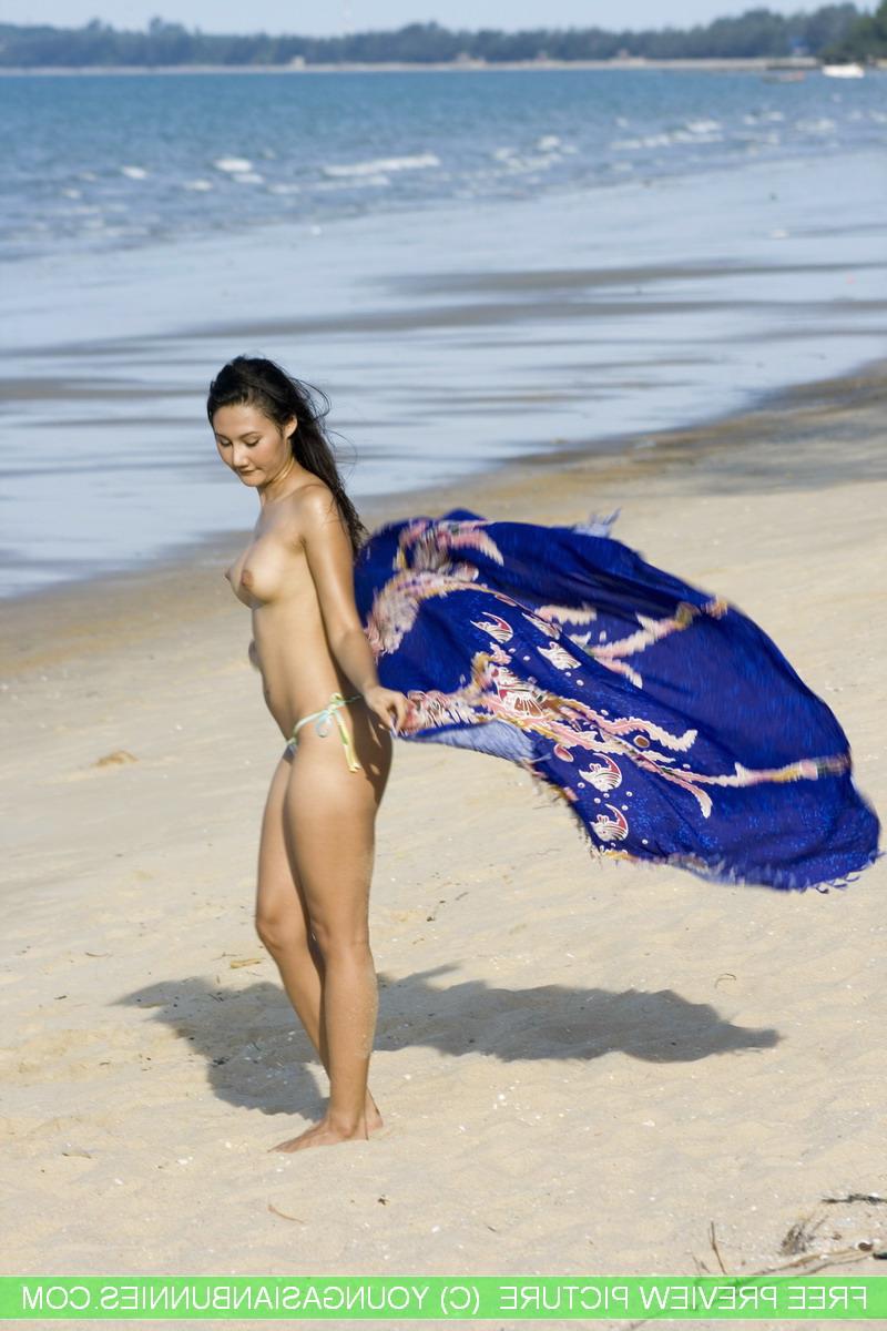 16P Asian amateur wanders along a beach in just her bikini bottoms