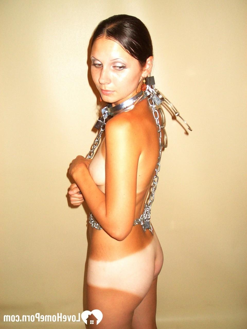 20P Brunette beauty with a handcuffs strips and shows her hot body with tan lines