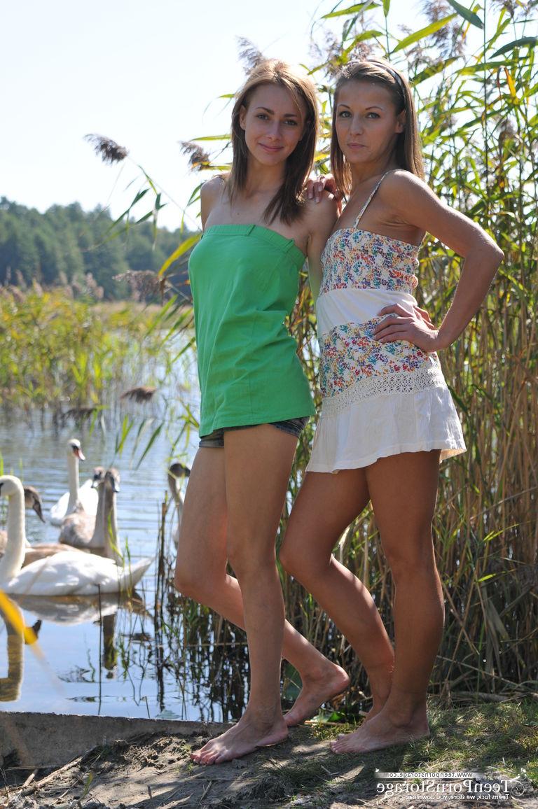 20P Young lesbians Nastya and Ashly get undressed atop a blanket on a dock