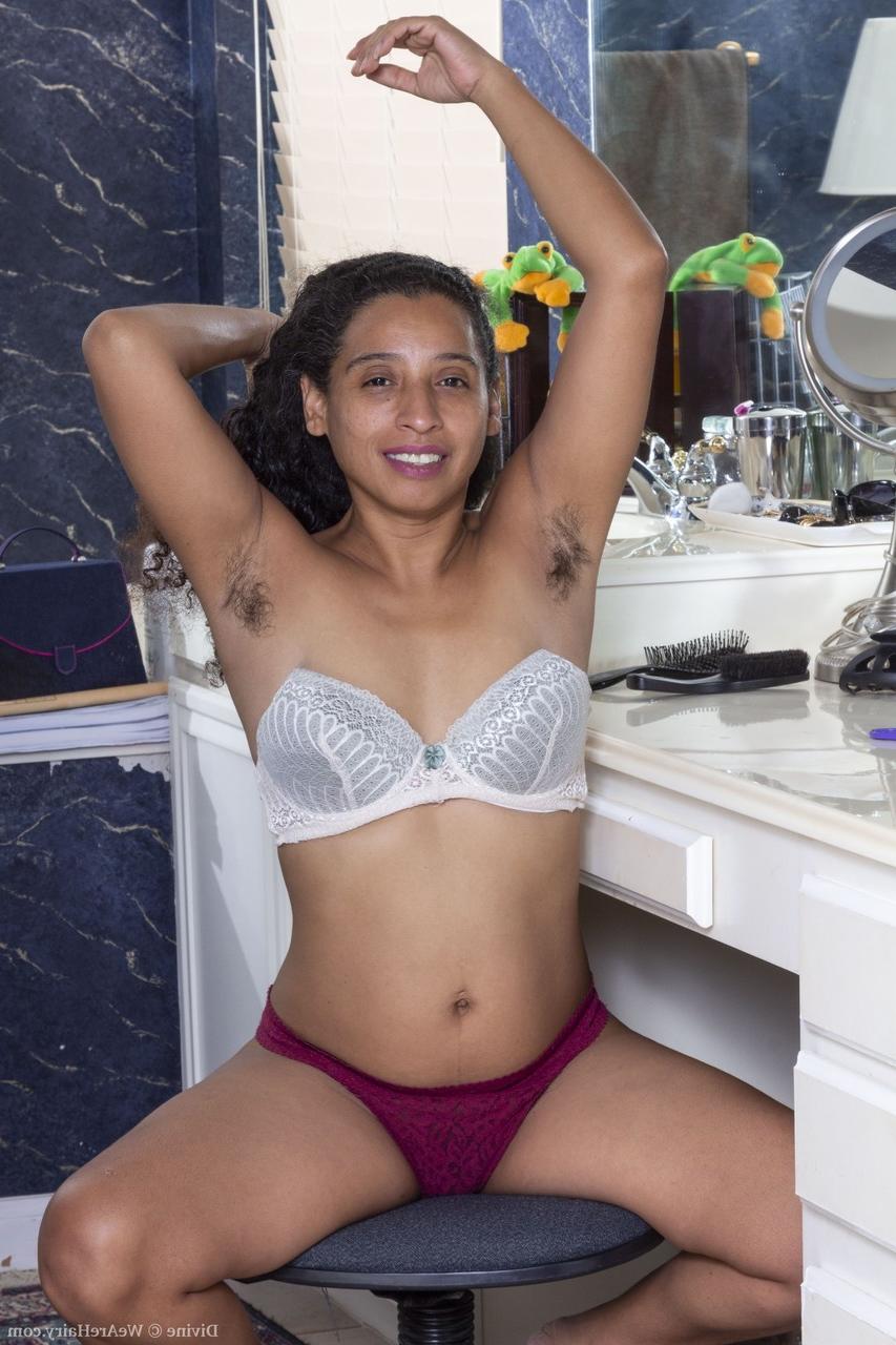 20P Exotic ebony babe Divine displaying her hairy armpits and furry coochie