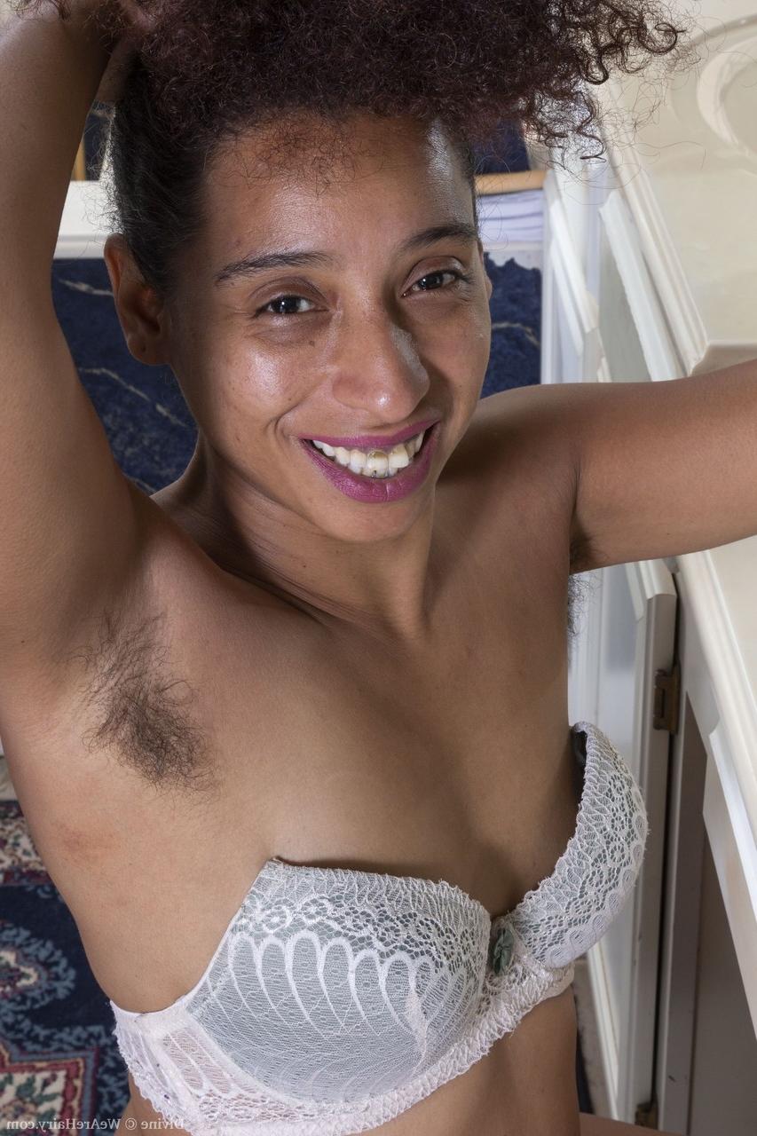 20P Exotic ebony babe Divine displaying her hairy armpits and furry coochie