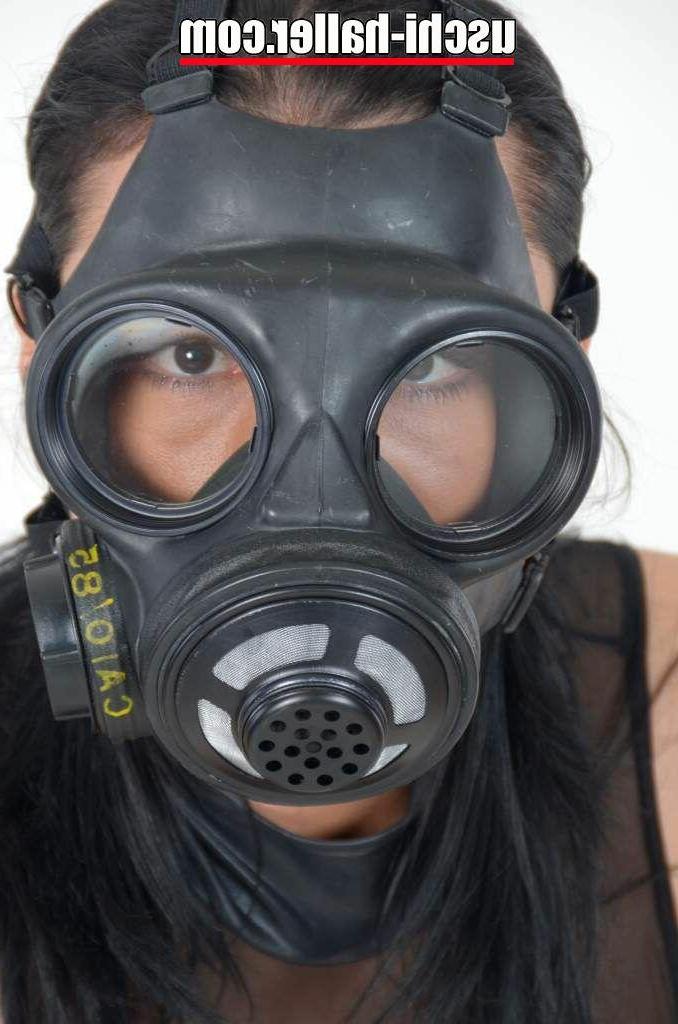 15P Fetish model Eve Gagging lifts up a short dress while sporting a gas mask
