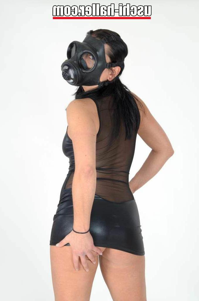 15P Fetish model Eve Gagging lifts up a short dress while sporting a gas mask
