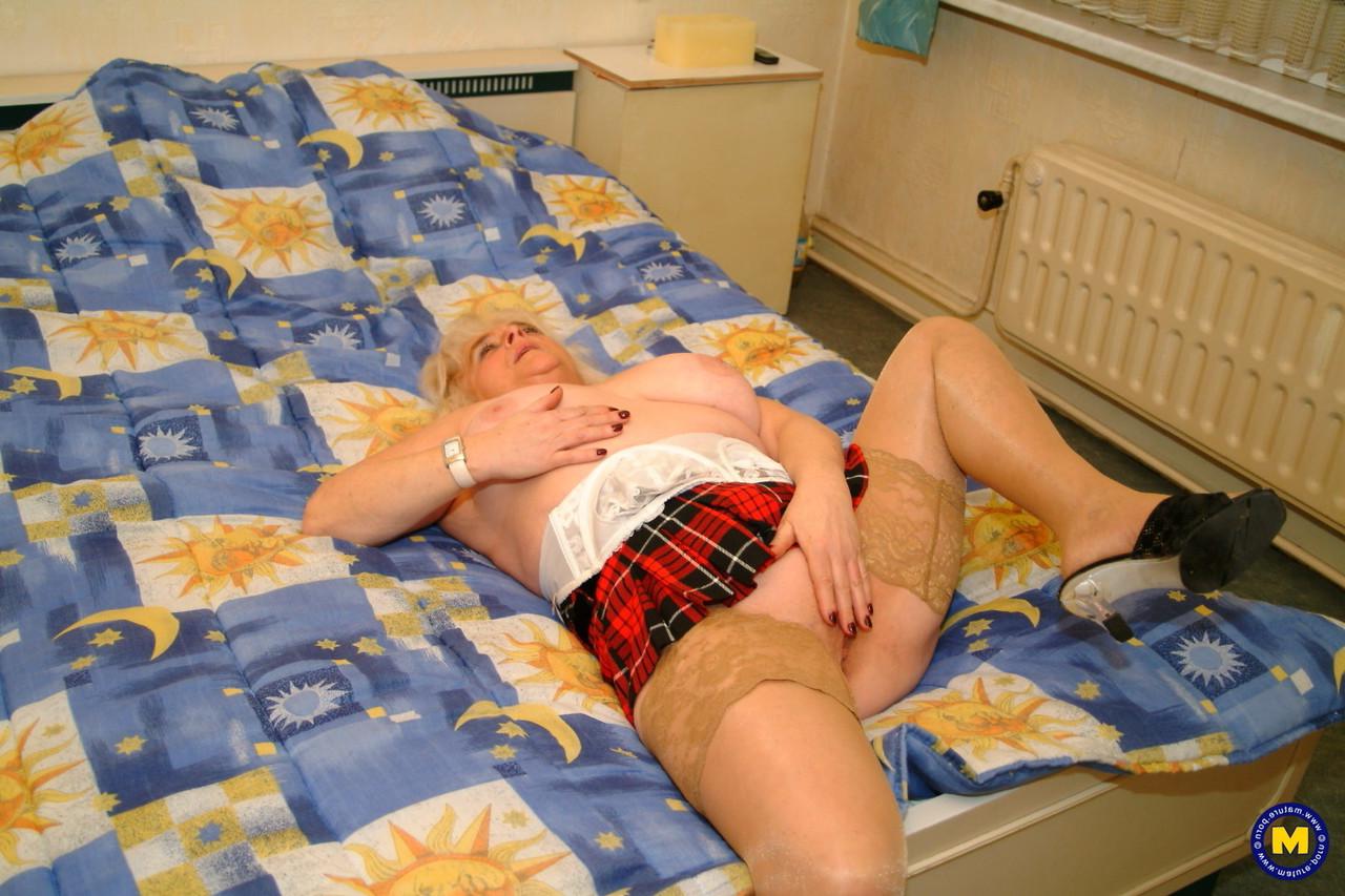 20P Mature Dutch housewife Henrietta posing in her top, stockings and short skirt