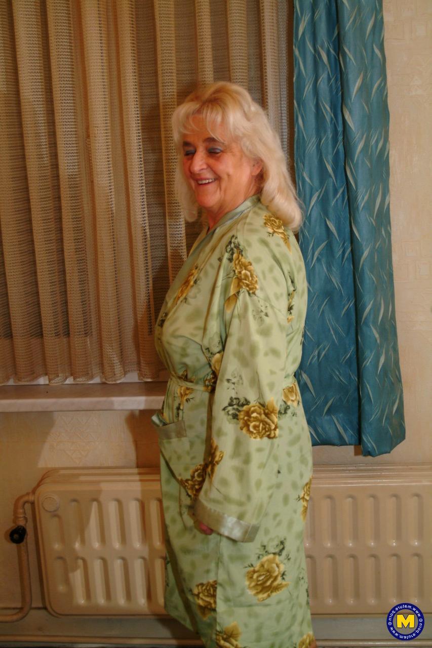 20P Mature Dutch housewife Henrietta posing in her top, stockings and short skirt