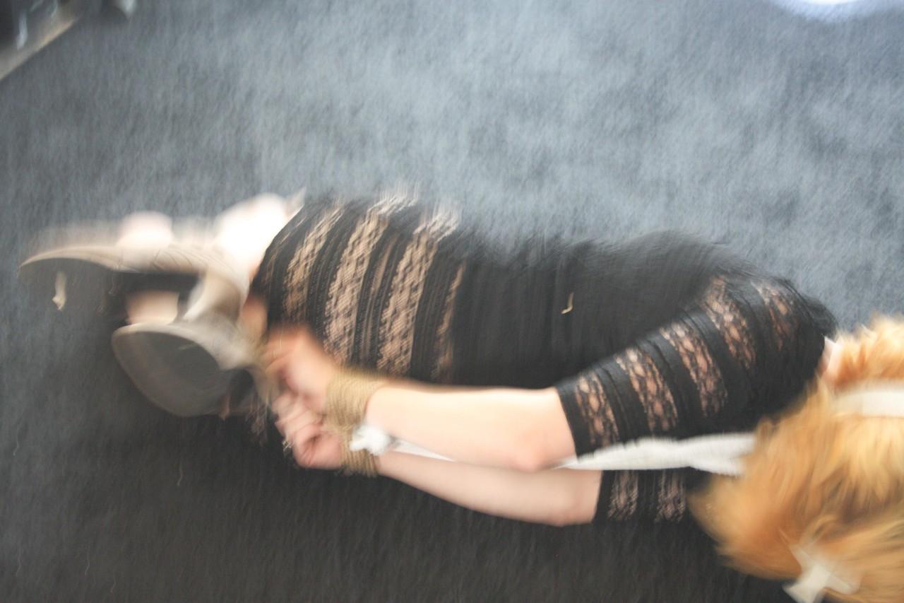 20P Fully clothed babe Cindy struggles helplessly while hogtied on the floor
