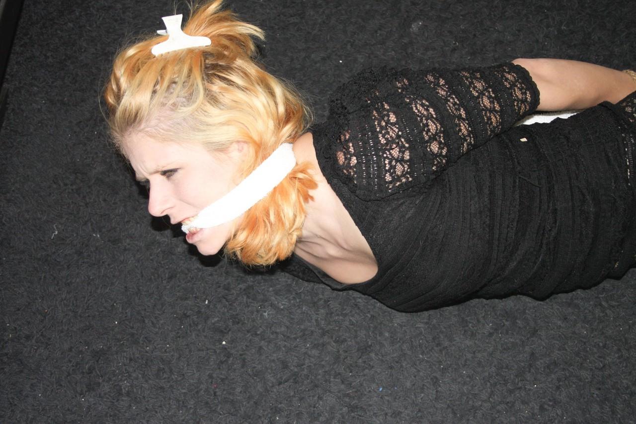 20P Fully clothed babe Cindy struggles helplessly while hogtied on the floor