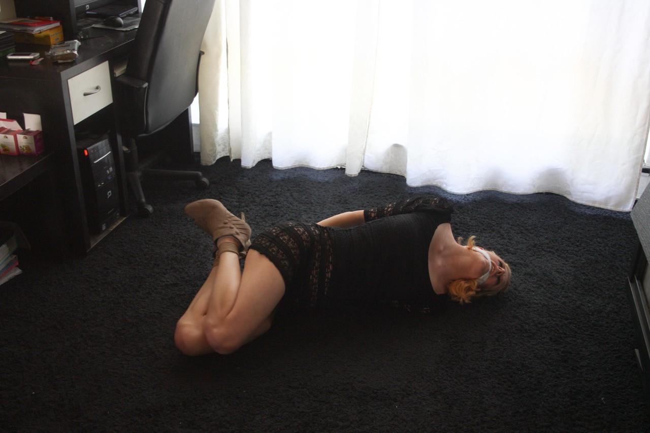 20P Fully clothed babe Cindy struggles helplessly while hogtied on the floor