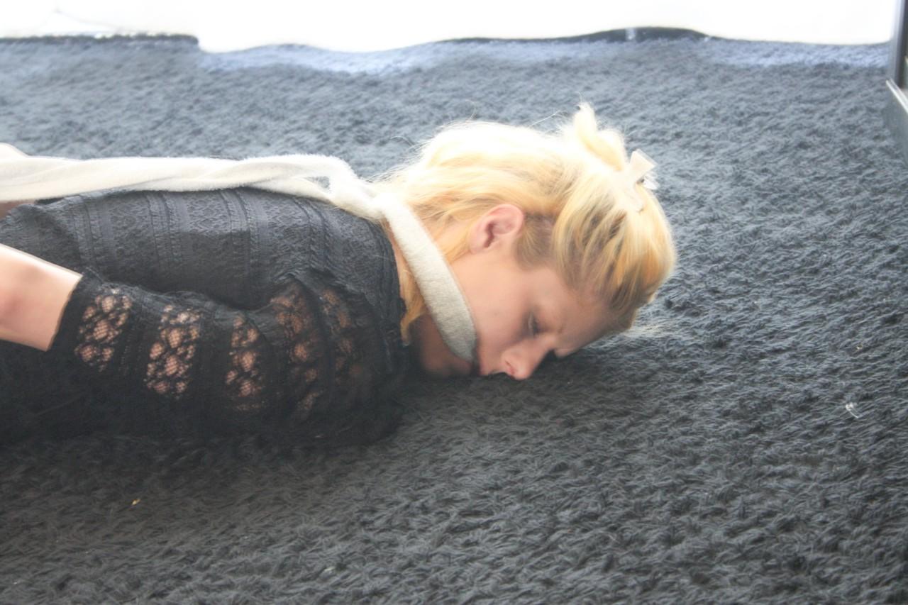 20P Fully clothed babe Cindy struggles helplessly while hogtied on the floor