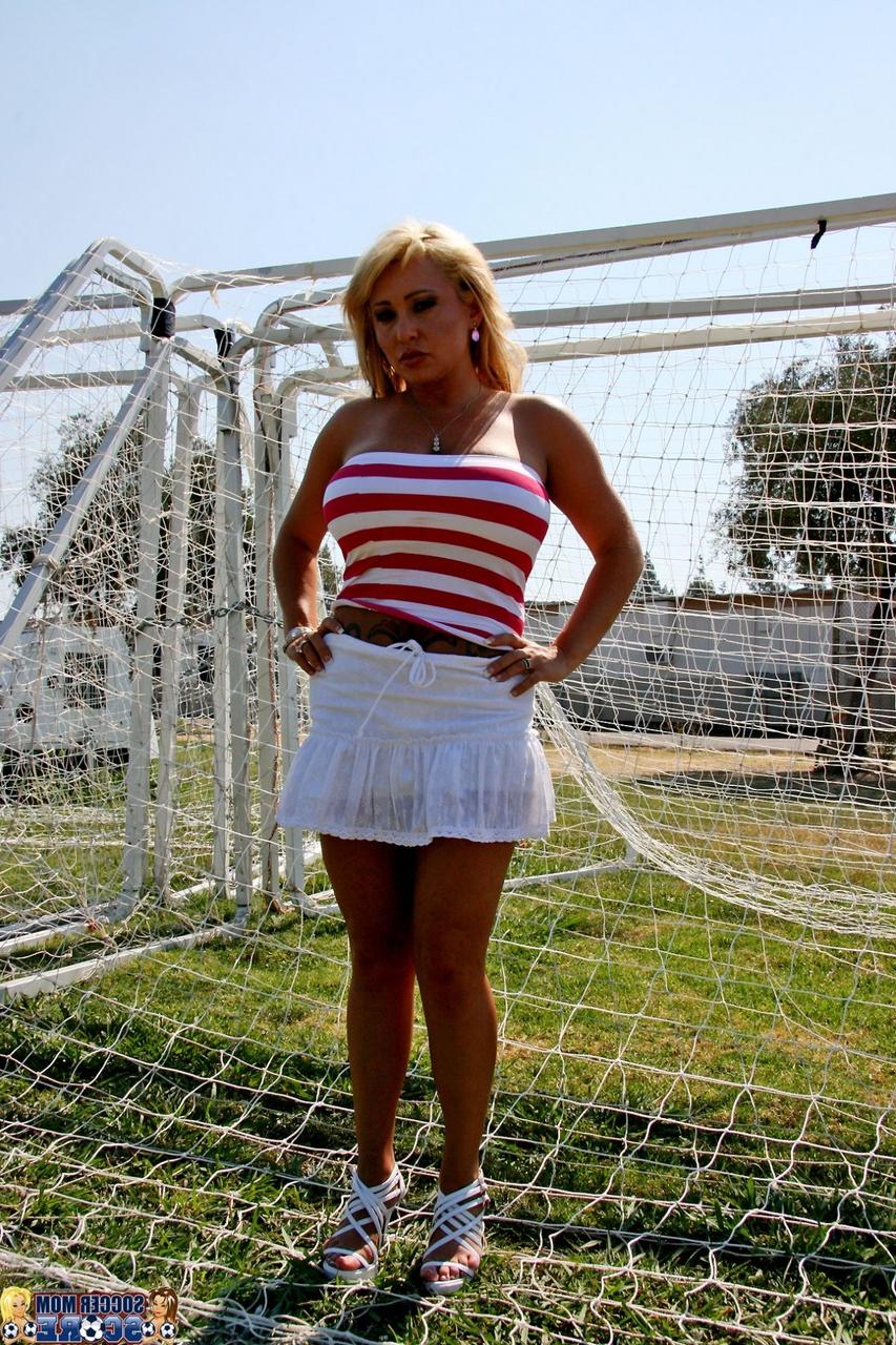 17P Milan, maman blonde du football, donne à un jeune joueur un aperçu illicite de sa jupe.