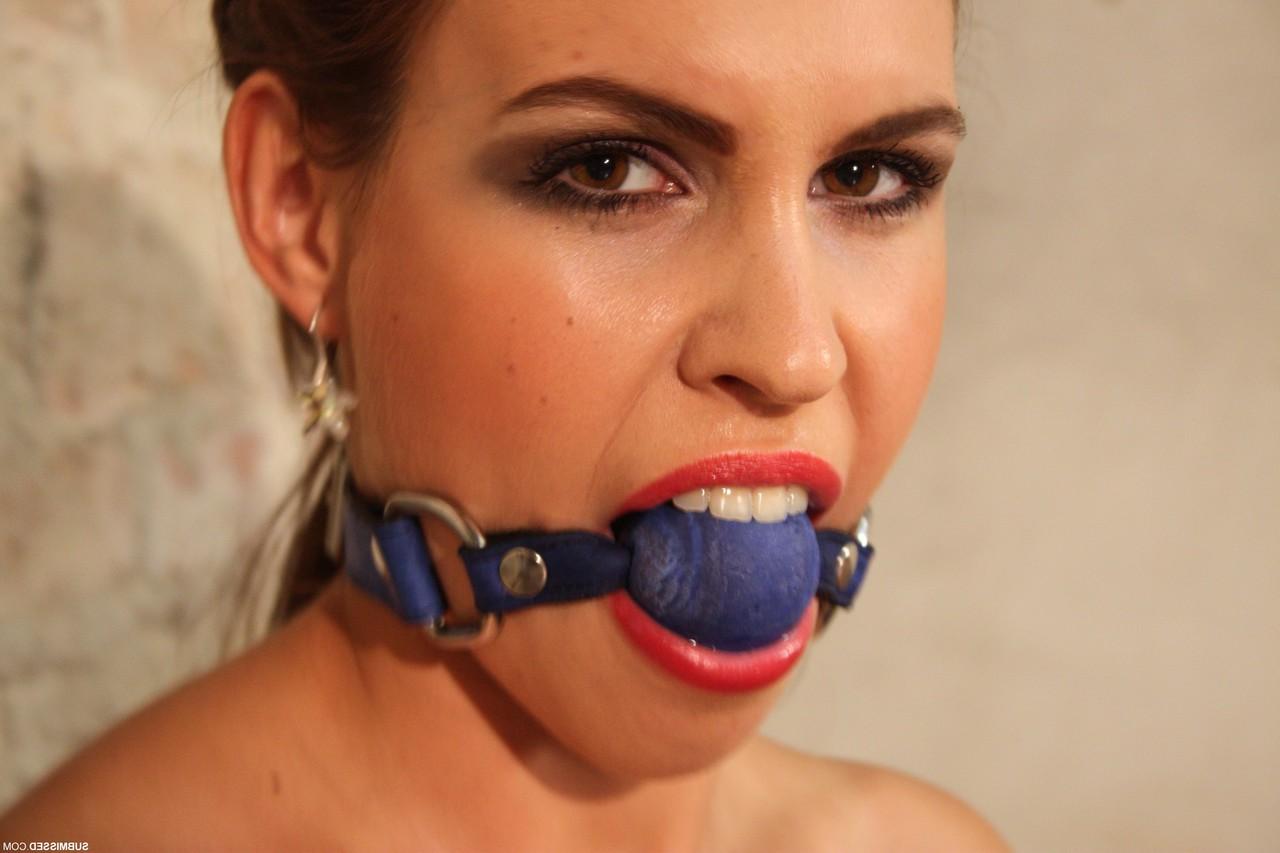 20P Topless ball-gagged Jenny struggles to free herself from rope bondage