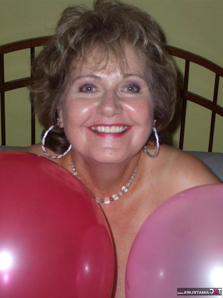 20P Older lady Busty Bliss plays with balloons before uncupping her natural tits