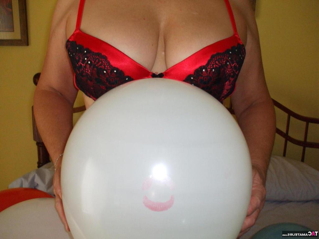 20P Older lady Busty Bliss plays with balloons before uncupping her natural tits