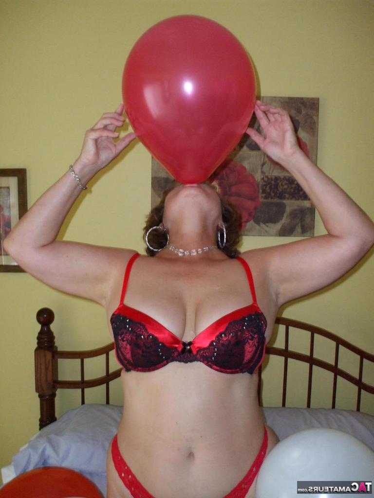 20P Older lady Busty Bliss plays with balloons before uncupping her natural tits
