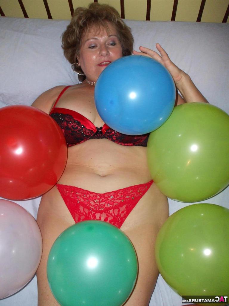 20P Older lady Busty Bliss plays with balloons before uncupping her natural tits