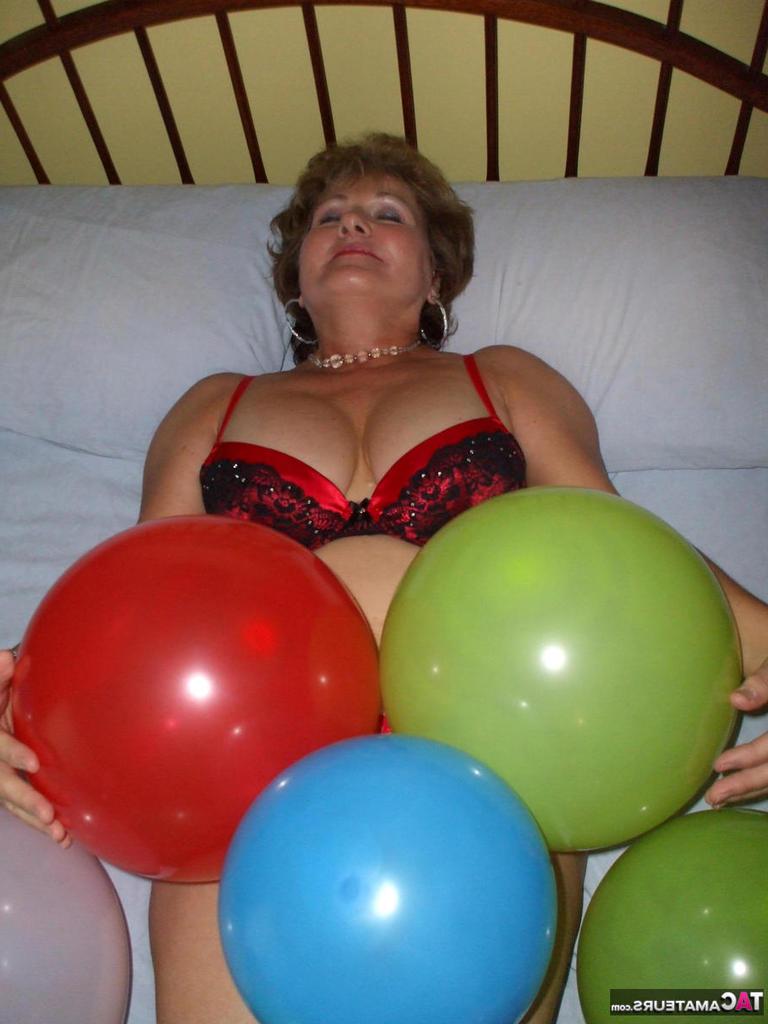 20P Older lady Busty Bliss plays with balloons before uncupping her natural tits