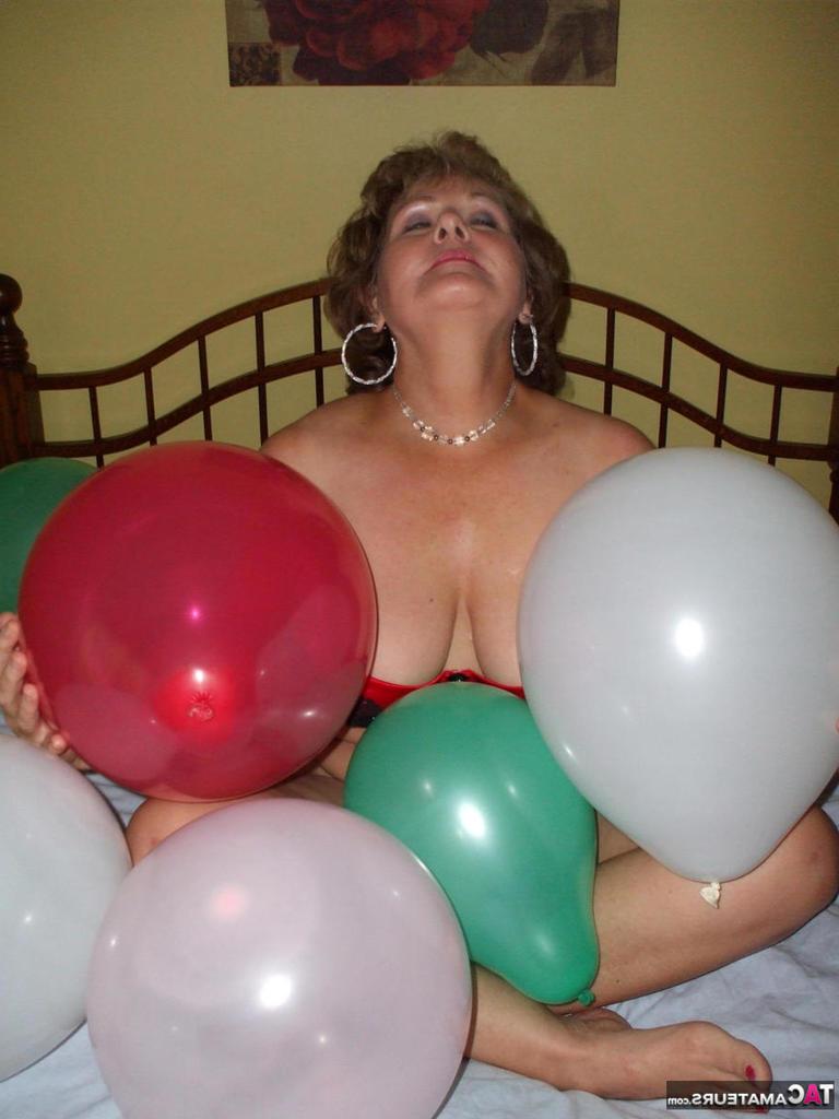 20P Older lady Busty Bliss plays with balloons before uncupping her natural tits