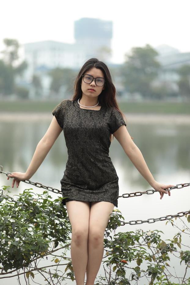 20P Nerdy Asian babe Natalia posing in her sexy black dress in public