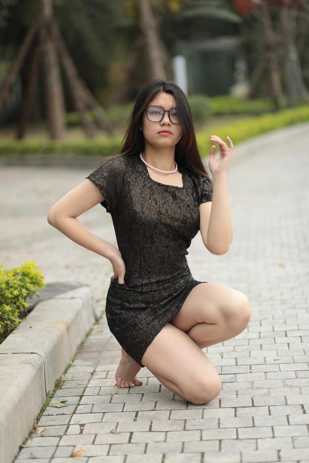 20P Nerdy Asian babe Natalia posing in her sexy black dress in public