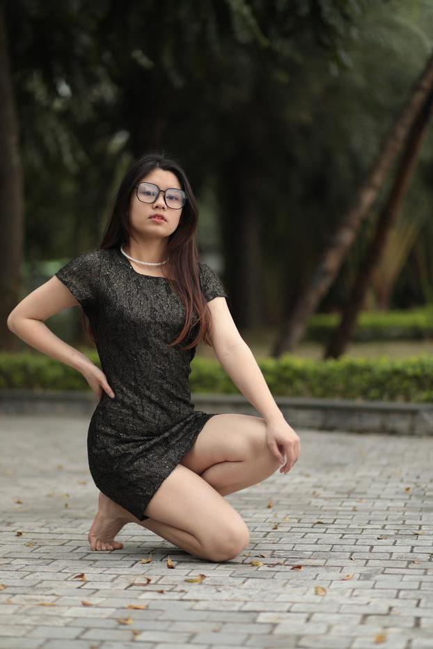 20P Nerdy Asian babe Natalia posing in her sexy black dress in public