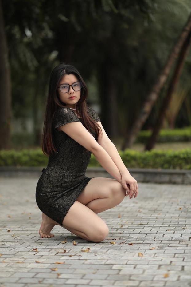 20P Nerdy Asian babe Natalia posing in her sexy black dress in public