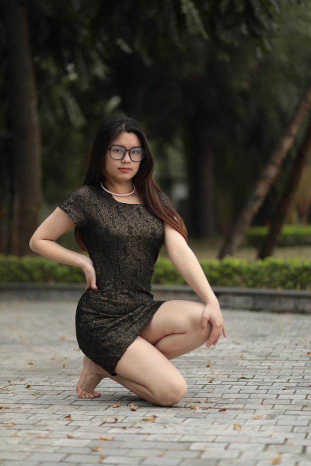 20P Nerdy Asian babe Natalia posing in her sexy black dress in public