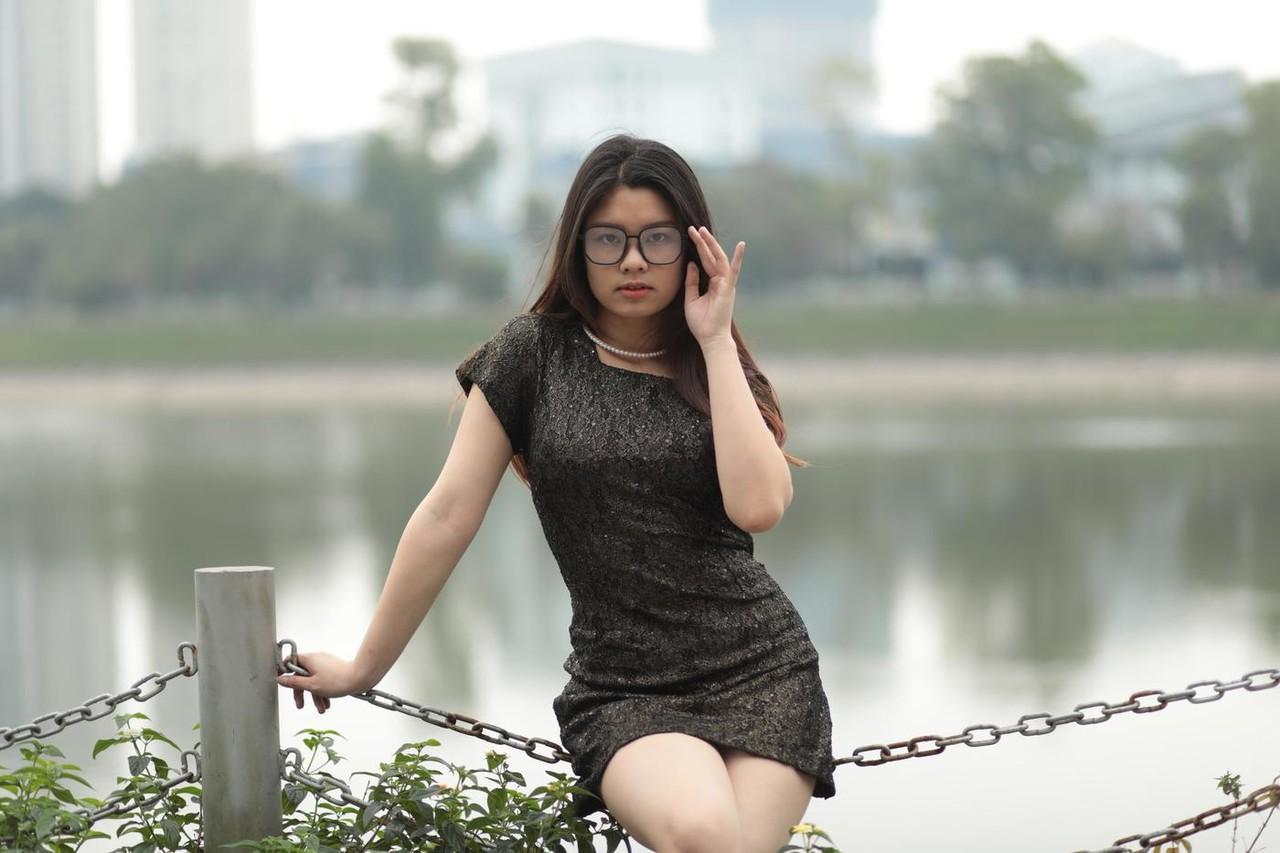 20P Nerdy Asian babe Natalia posing in her sexy black dress in public