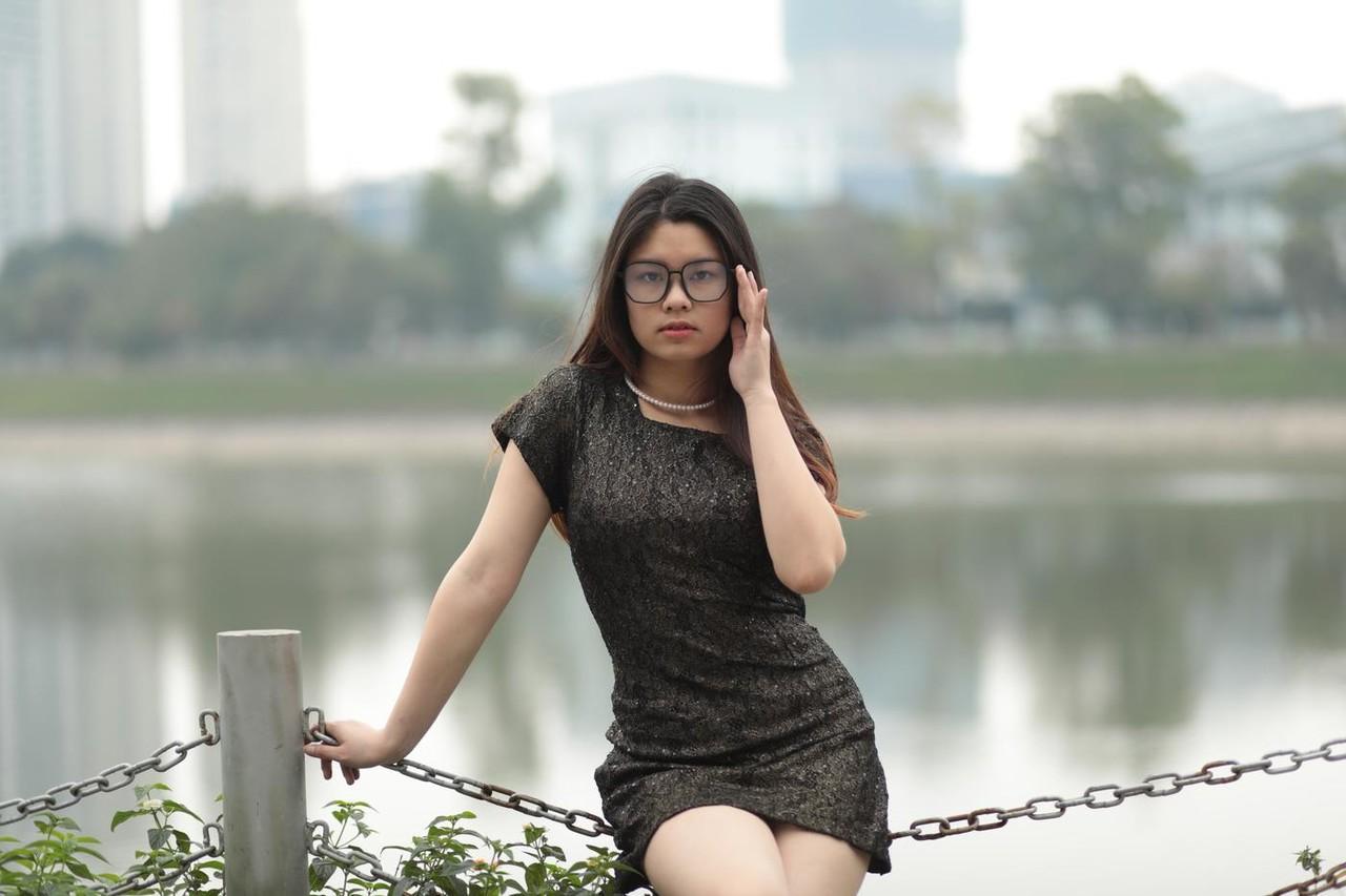 20P Nerdy Asian babe Natalia posing in her sexy black dress in public