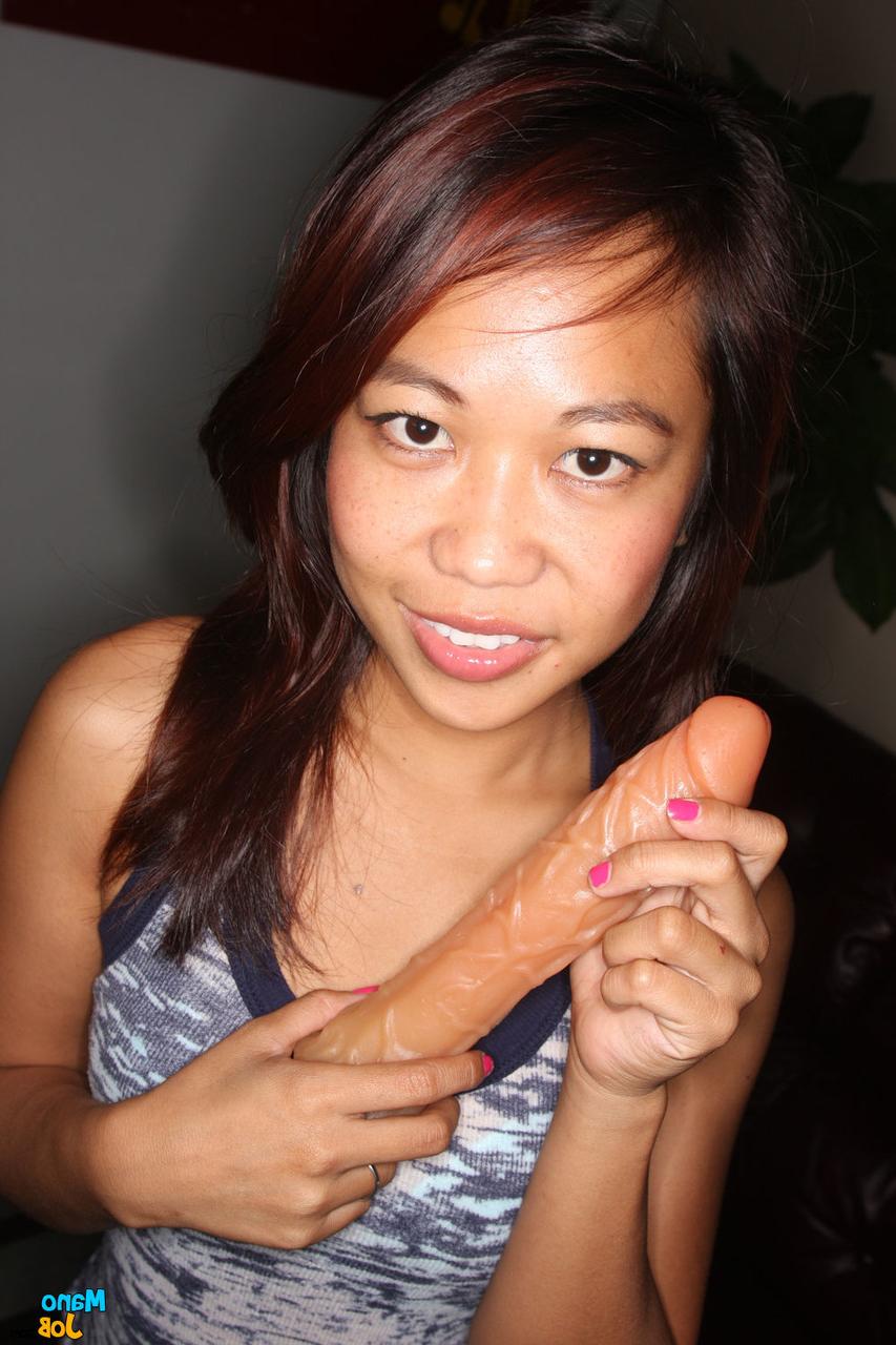 15P Cute Asian girl Myla Montez strips naked before tugging on a big cock