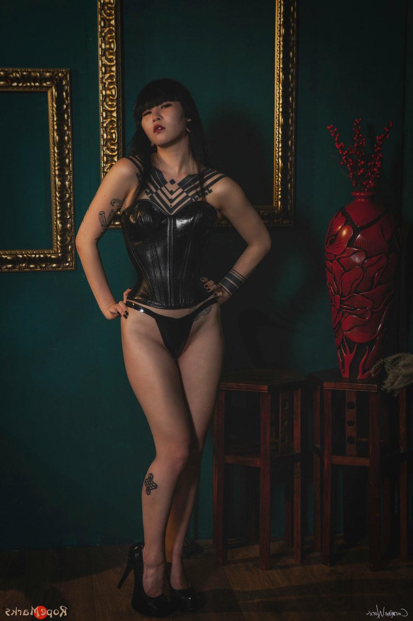 16P Asian solo model Flawless Meow poses in a leather corset and high heels