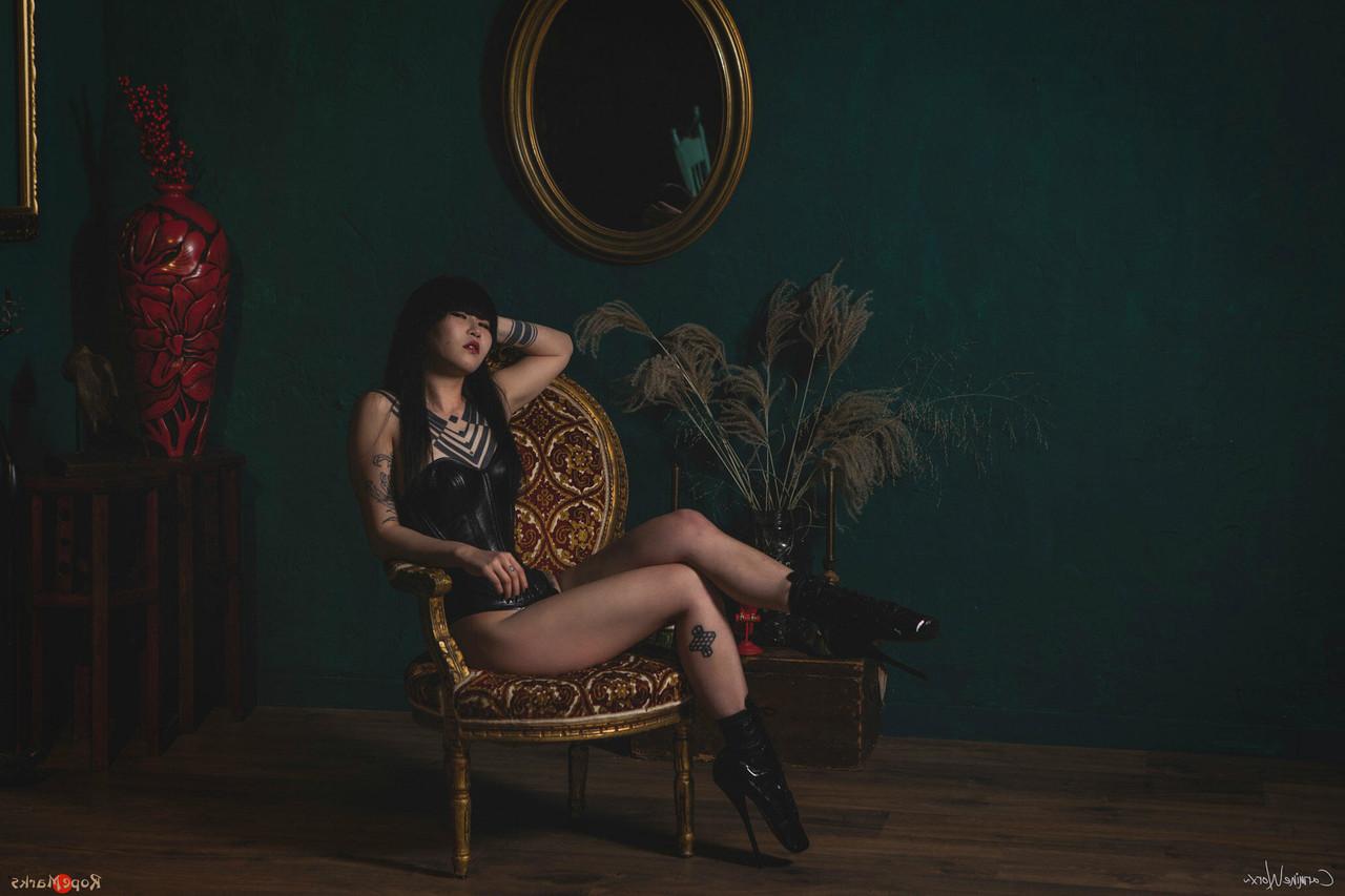 16P Asian solo model Flawless Meow poses in a leather corset and high heels