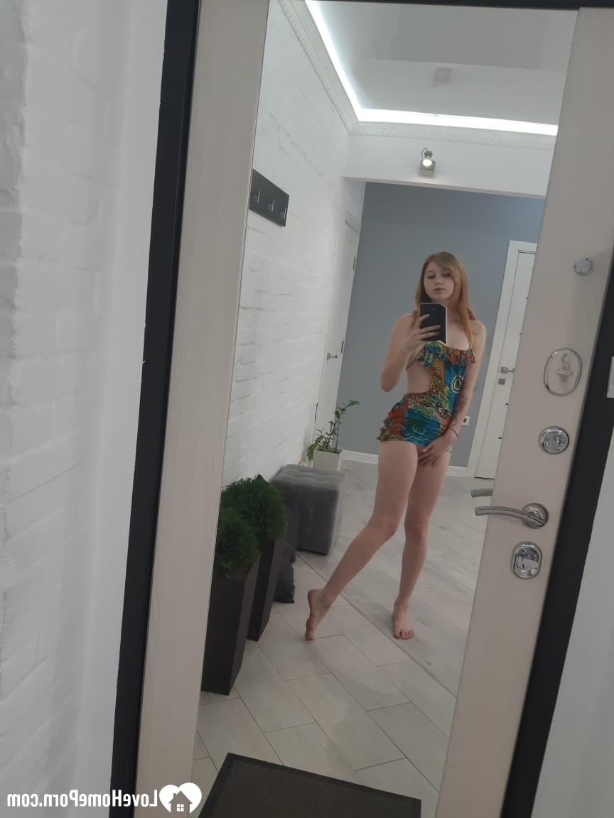 20P Chica pelirroja caliente se quita su vestido colorido y posa desnuda en el espejo