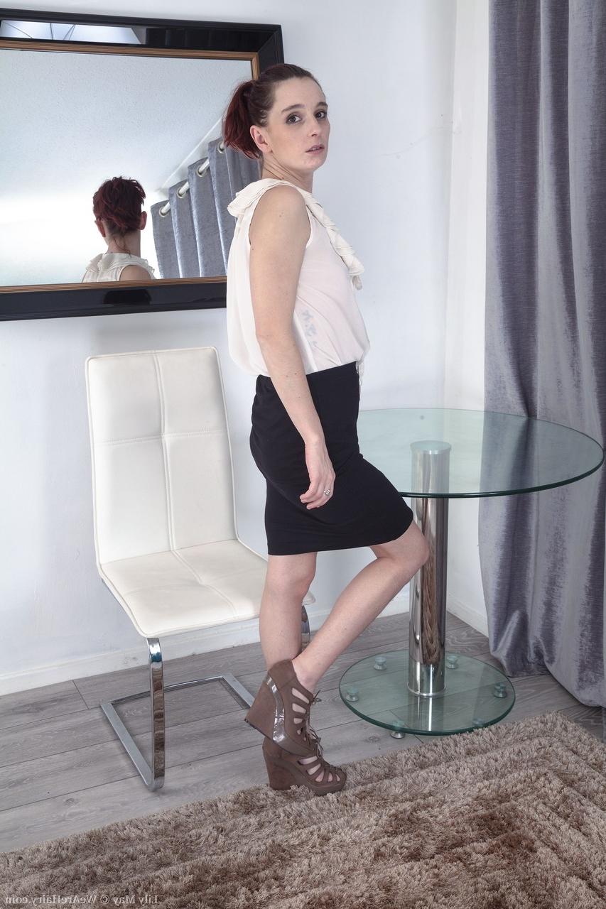 20P Gorgeous British babe Lily May stripping and displaying her hairy crotch