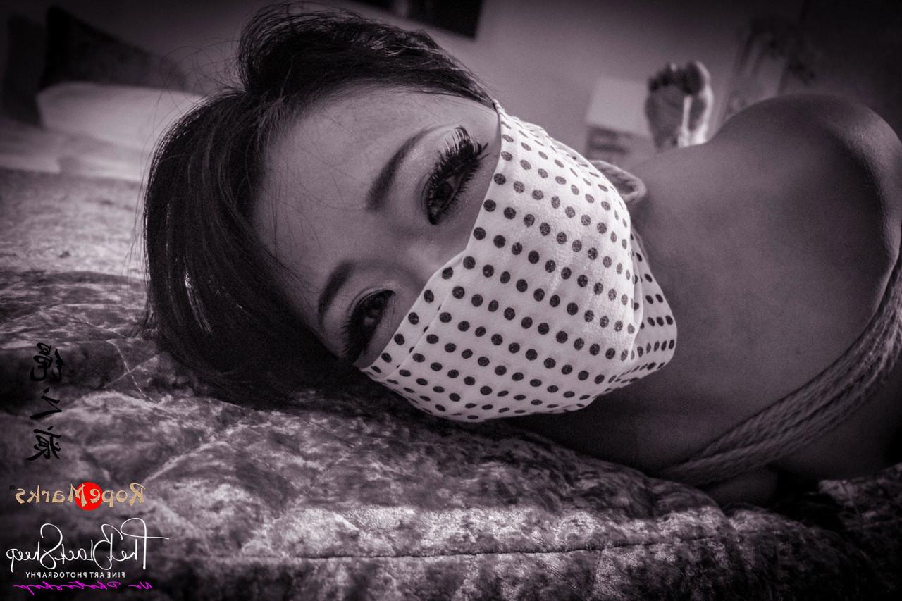 16P Asian chick is tied up with ropes on a bed before being blindfolded