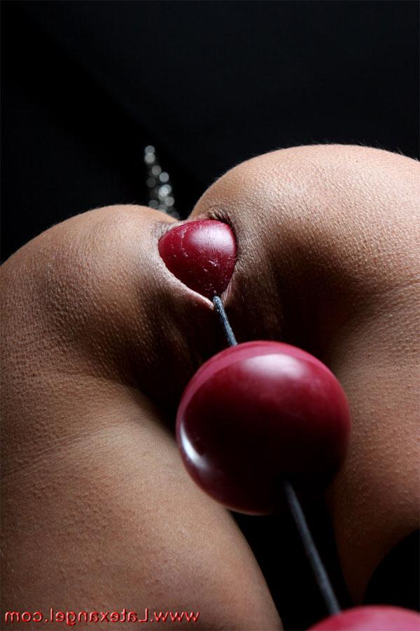 15P Restrained brunette drools while ball gagged and popping out anal beads