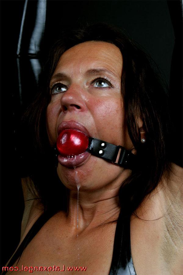 15P Restrained brunette drools while ball gagged and popping out anal beads