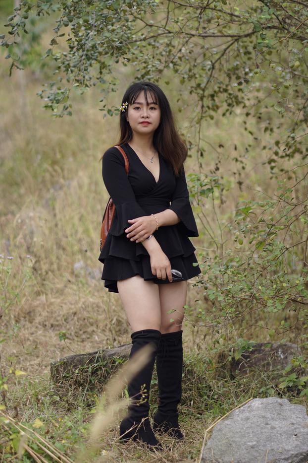 20P Gorgeous Asian babe posing in her black dress and boots in nature
