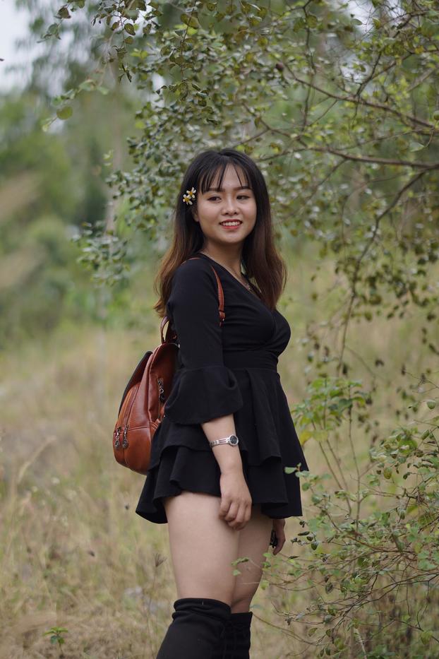 20P Gorgeous Asian babe posing in her black dress and boots in nature