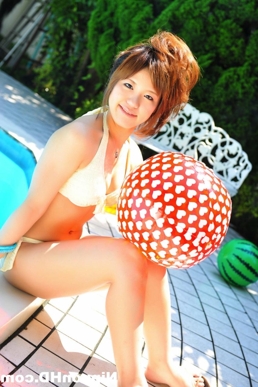 12P Japanese redhead holds a couple of balls while modelling a white bikini