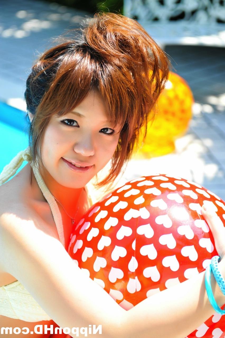 12P Japanese redhead holds a couple of balls while modelling a white bikini