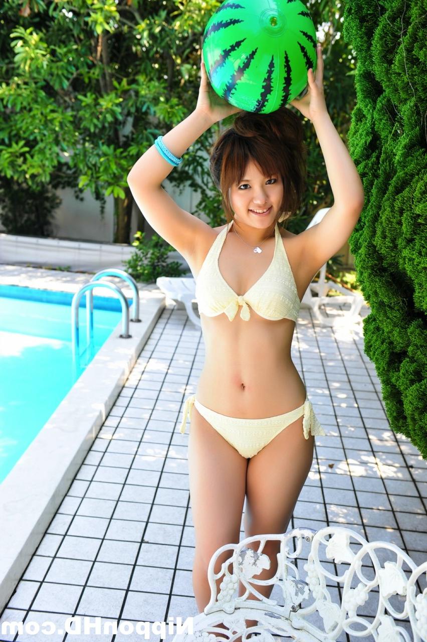 12P Japanese redhead holds a couple of balls while modelling a white bikini