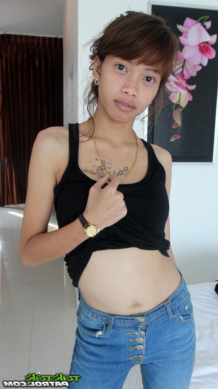 15P Adorable Thai girl cups a firm breast while petting her naked pussy