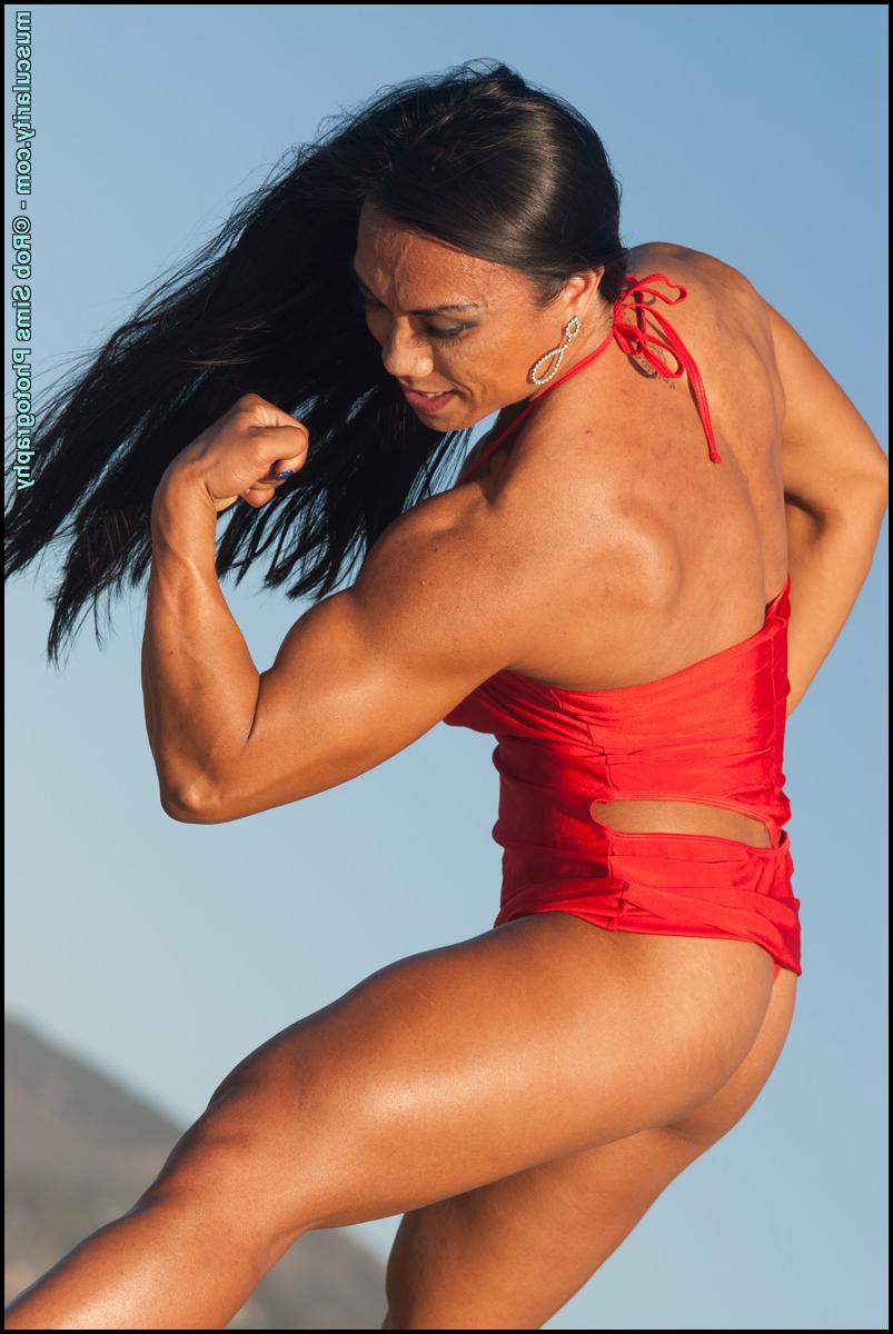 15P Le bodybuilder asiatique Tram Nguyen fléchit ses muscles sur une plage en maillot de bain.
