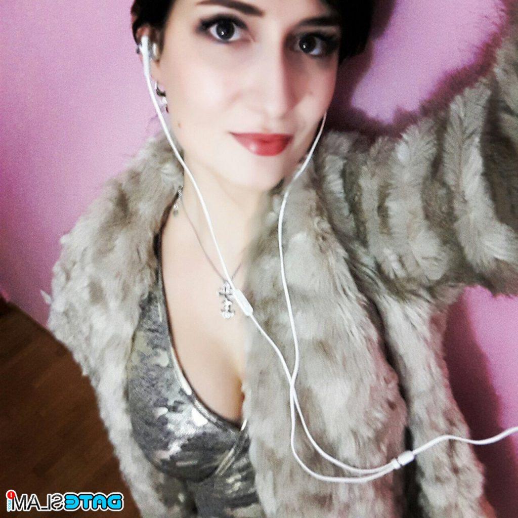 12P Busty hot brunette model Kelly in sexy clothing takes self shots indoors & out