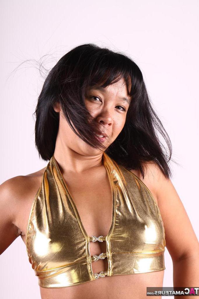 20P Asiática amateur juega con su cabello mientras modela un traje dorado