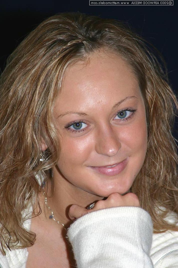 16P Blond amateur Danny undresses before showing her landing strip pussy on a bed